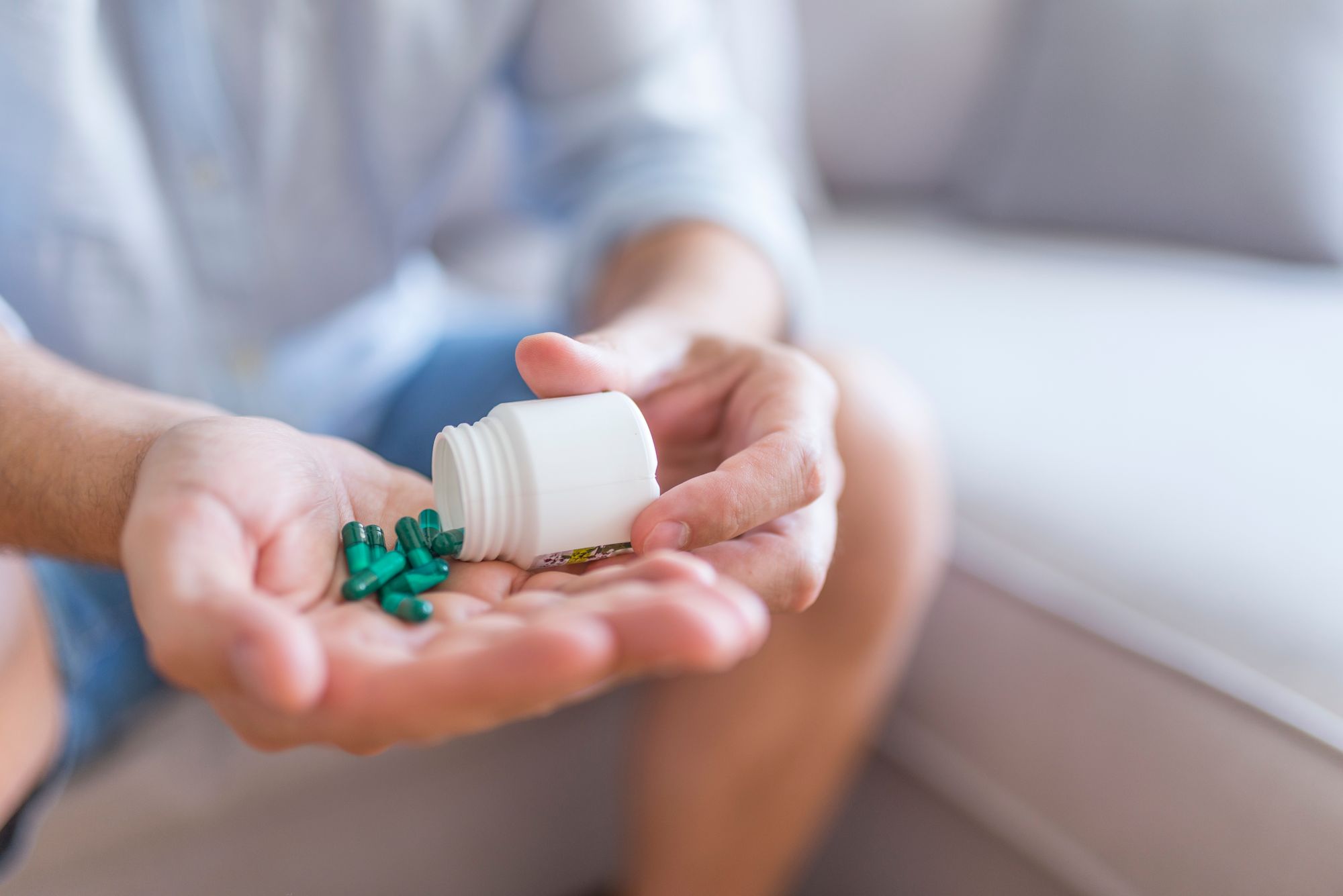 A man holding a bottle of Ginkgo Biloba supplement