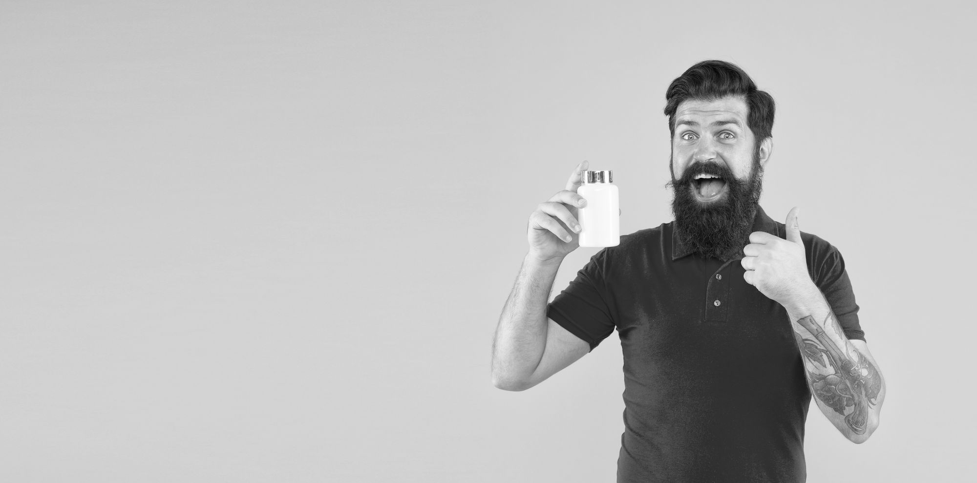 A man holding a bottle of Yohimbine supplement