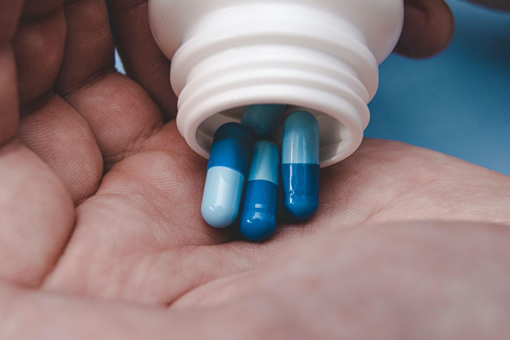 A man holding a bottle of herbal supplement for erectile dysfunction