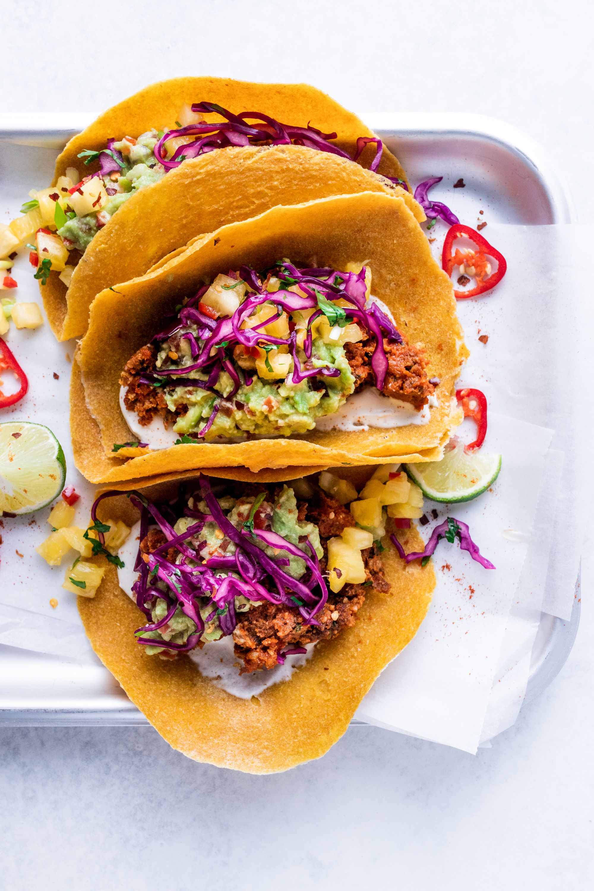 Raw vegan tacos with sunflower taco meat, cashew sour cream, guacamole and pineapple salsa
