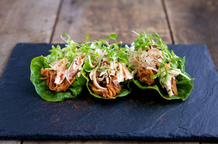 Raw enoki BBQ cups on a slate on a wooden background