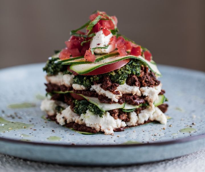 raw vegan lasagne on a light blue plate and white table