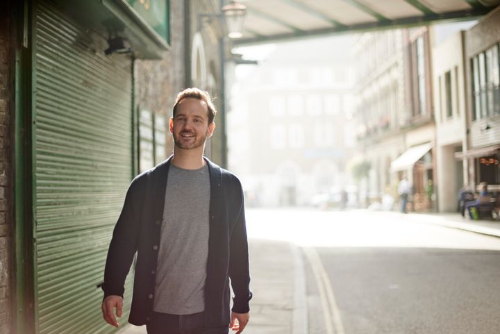 Russell James Clamp in Borough Market wearing a blue cardigan and grey t-shirt