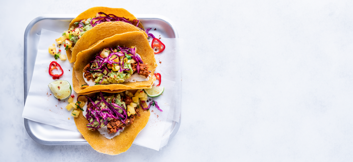 Raw vegan tacos with sunflower taco meat, cashew sour cream, guacamole and pineapple salsa