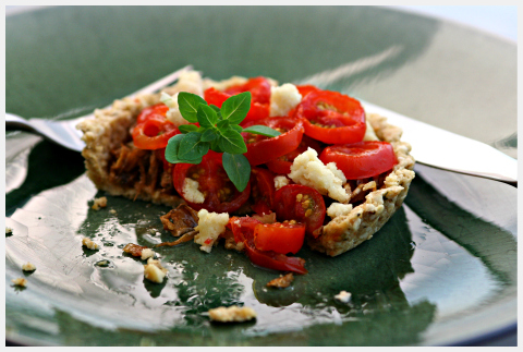 Raw food tomato tart on a green plate