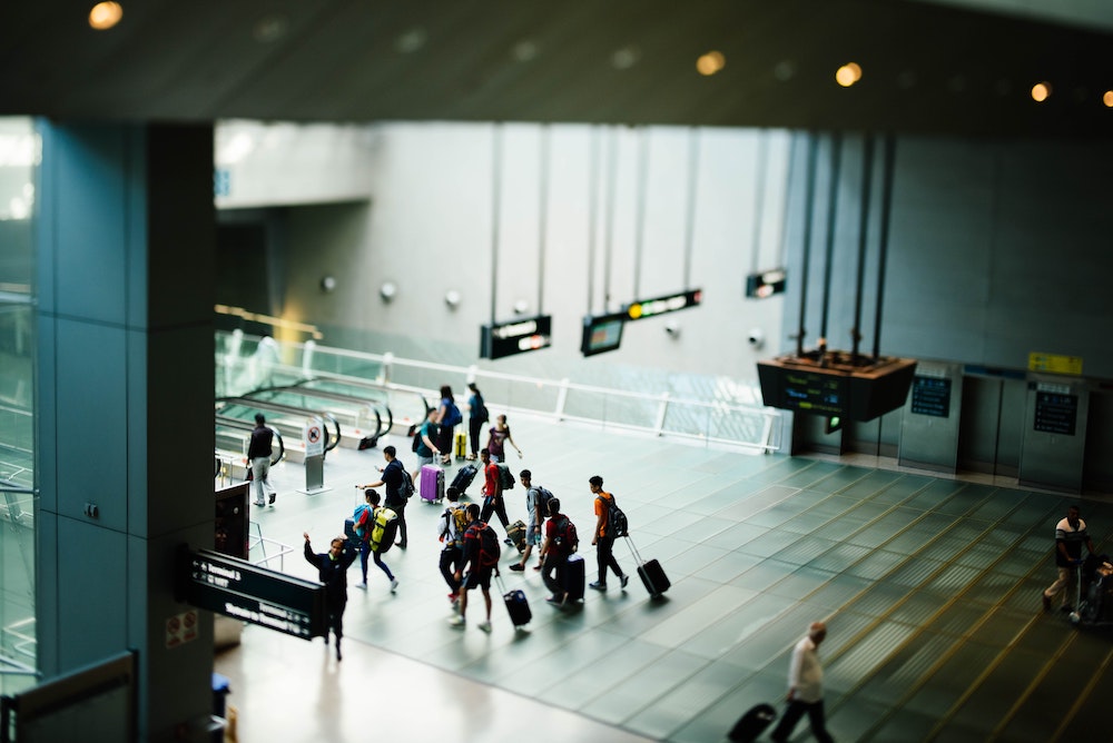 Passengers travelling to airport security scanners