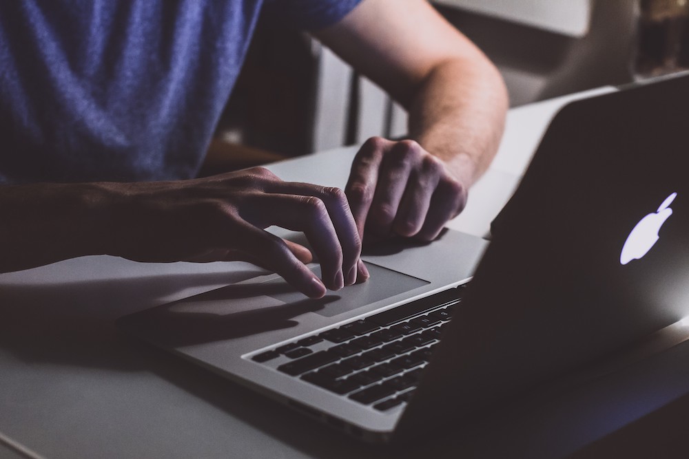 Guy working on his wellness business on a laptop