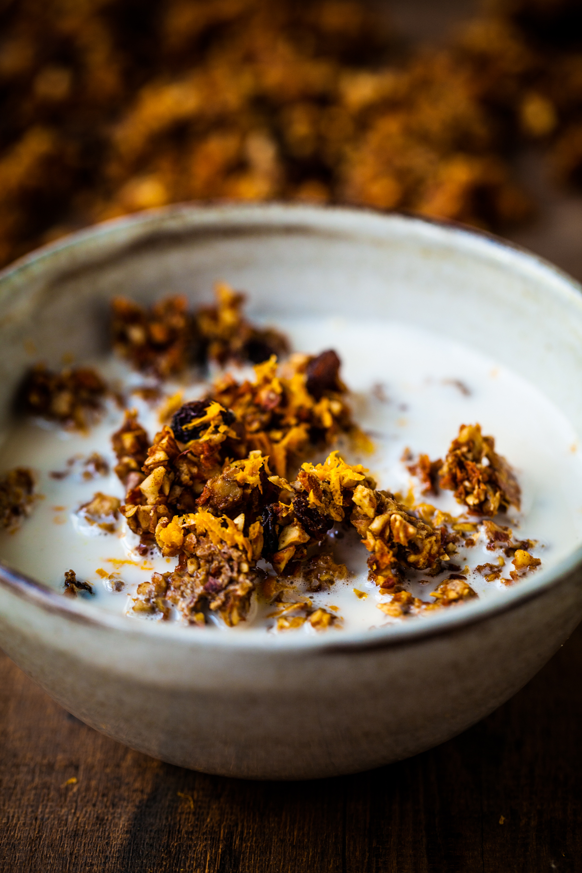 Raw vegan breakfast of granola in a bowl with almond milk