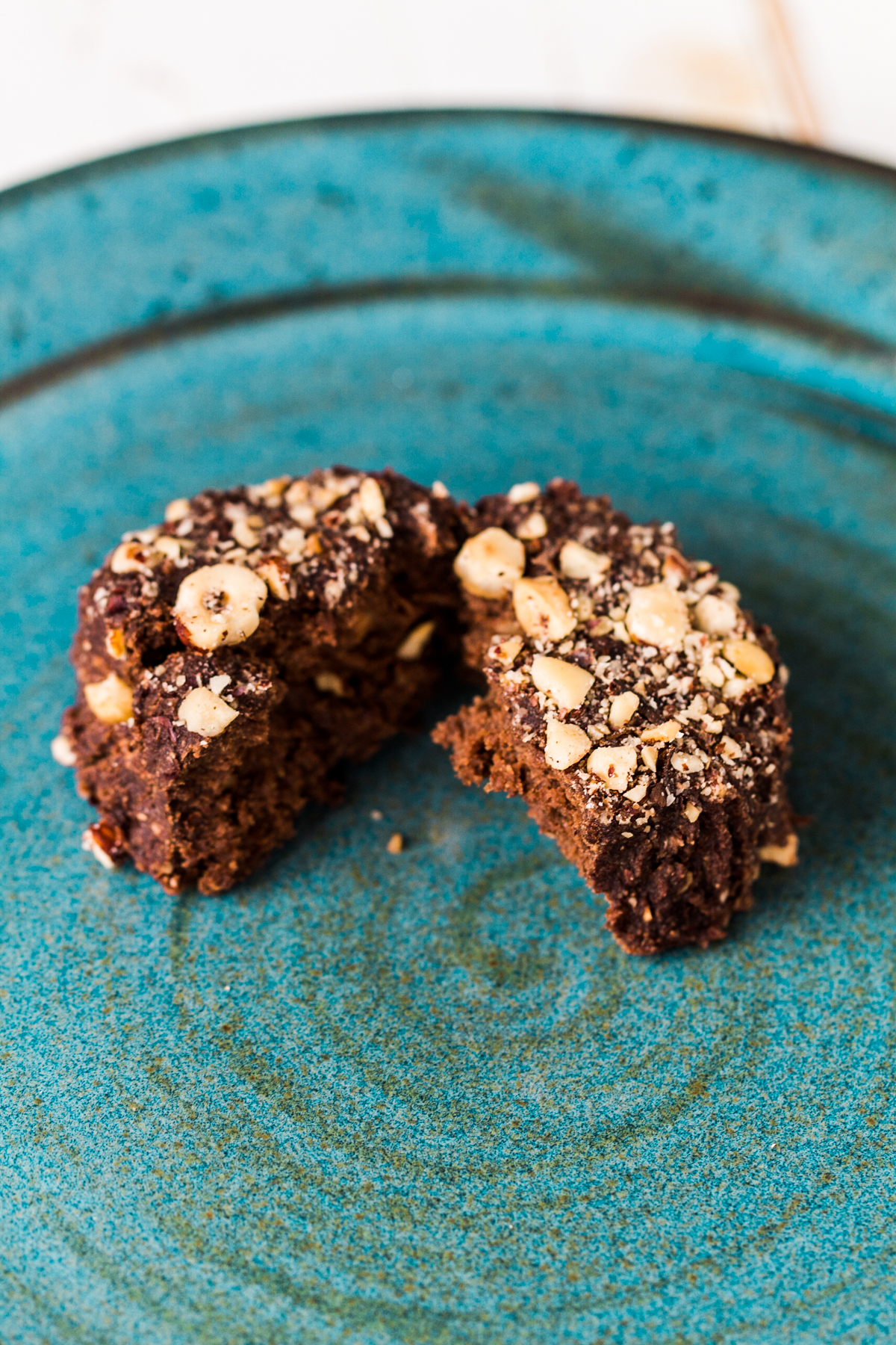 Raw chocolate breakfast roll, cut in half on a blue plate