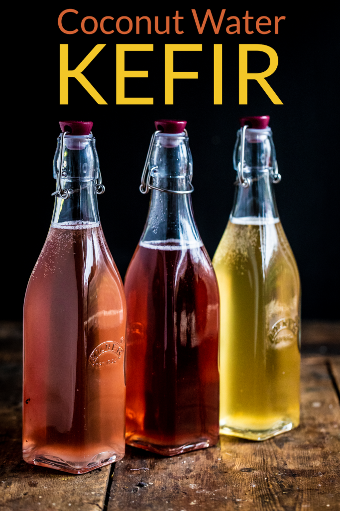 3 bottle of coconut water kefir lined up on a wooden surface