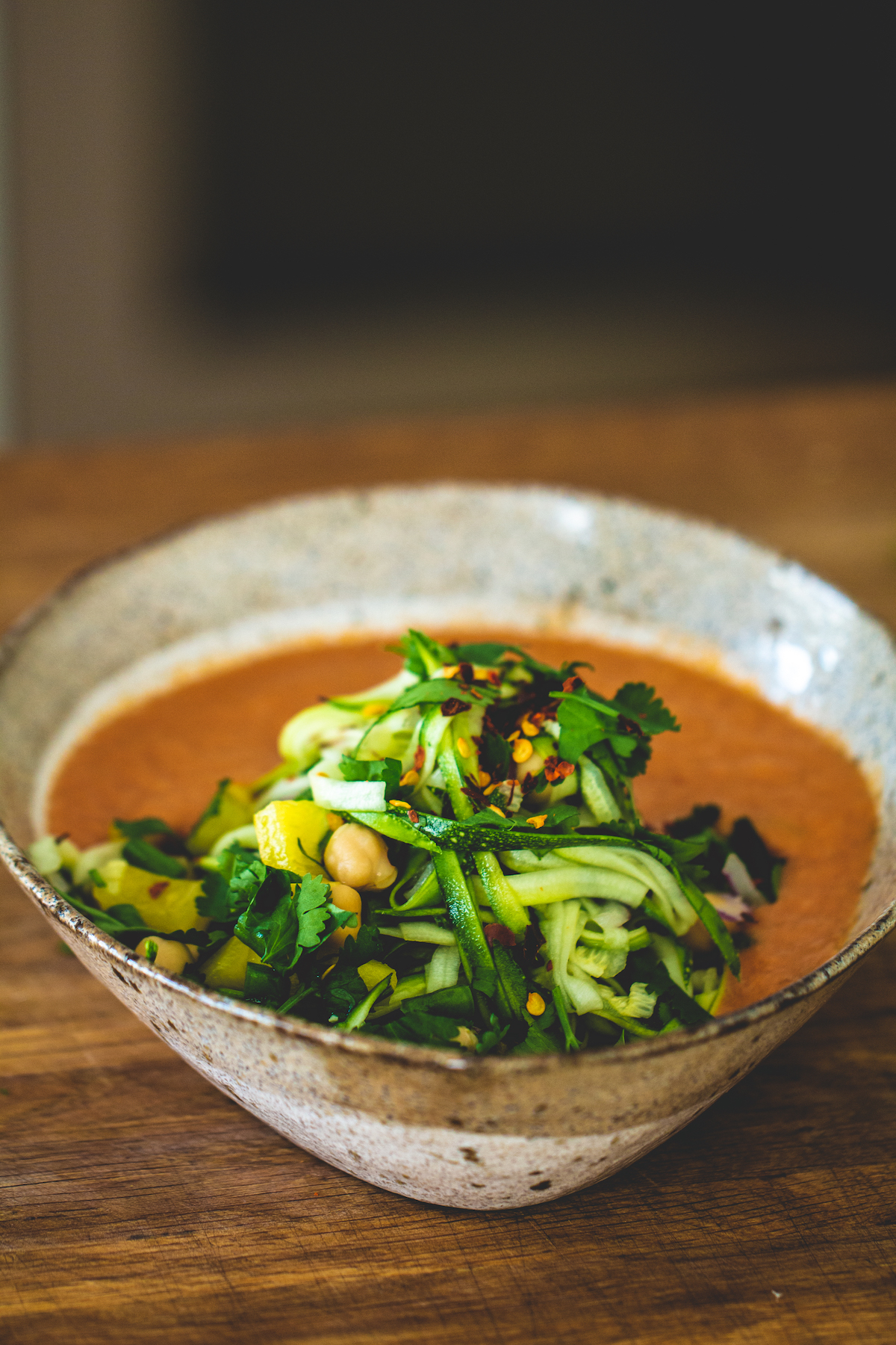 Curried tomato fettuccine in a white bowl on a wooden background