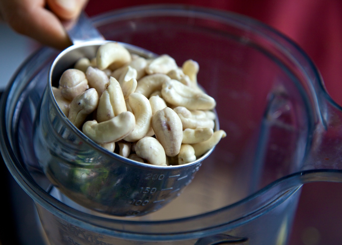 1 cup of soaked cashews going into a Vitamix jug