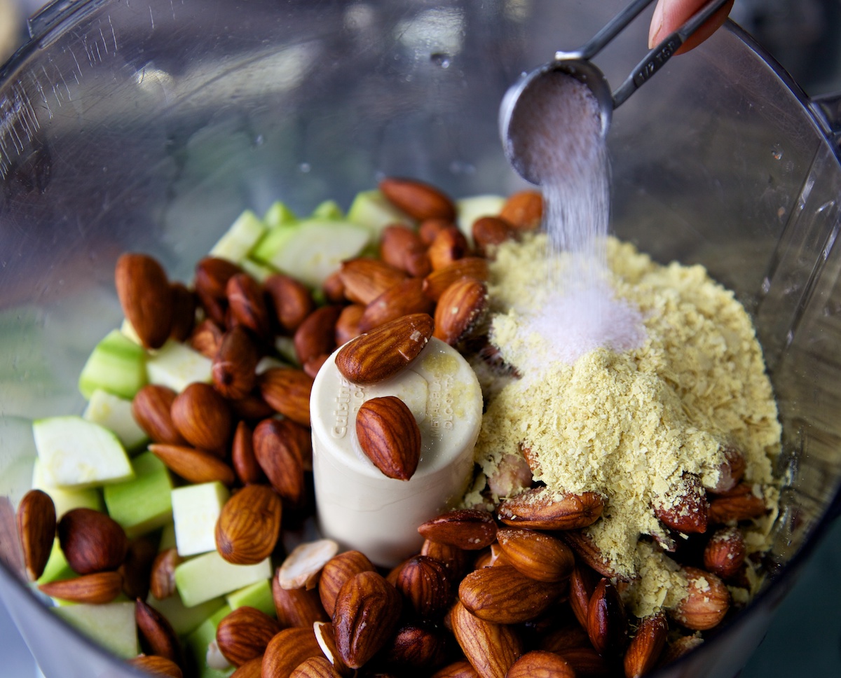 adding salt to the raw crouton ingredients in a food processor 