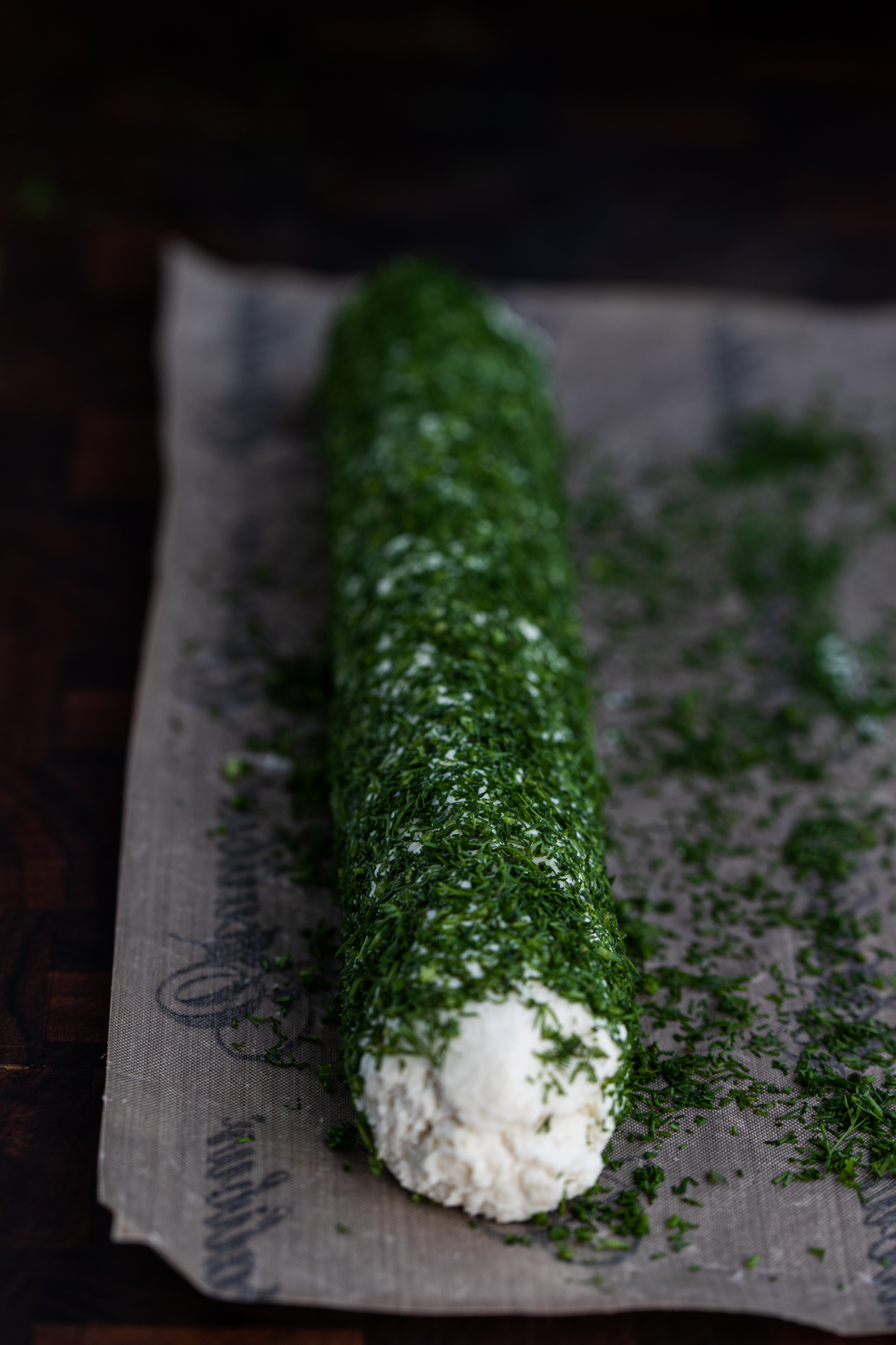 Macadamia nut cheese rolled in dill on a nonstick sheet