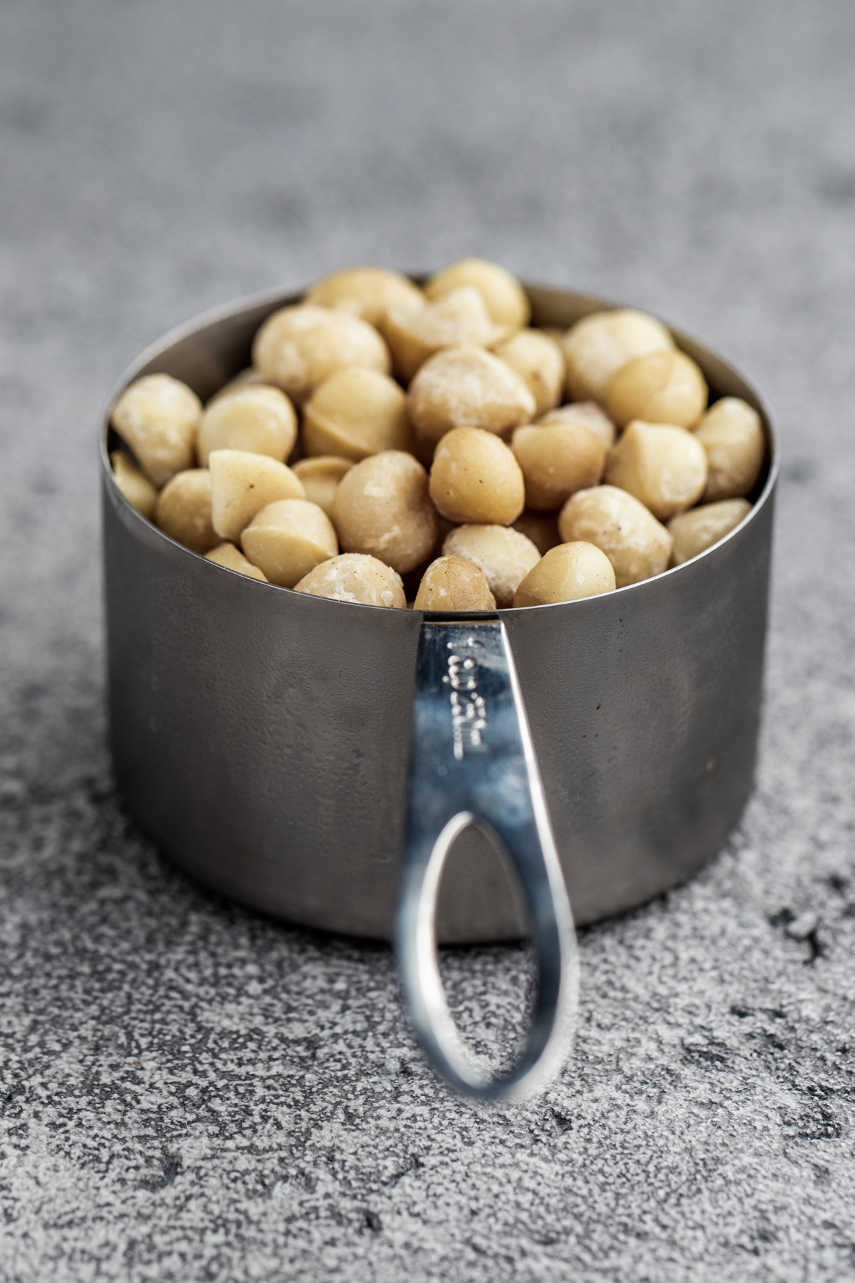 macadamia nuts in a cup measure