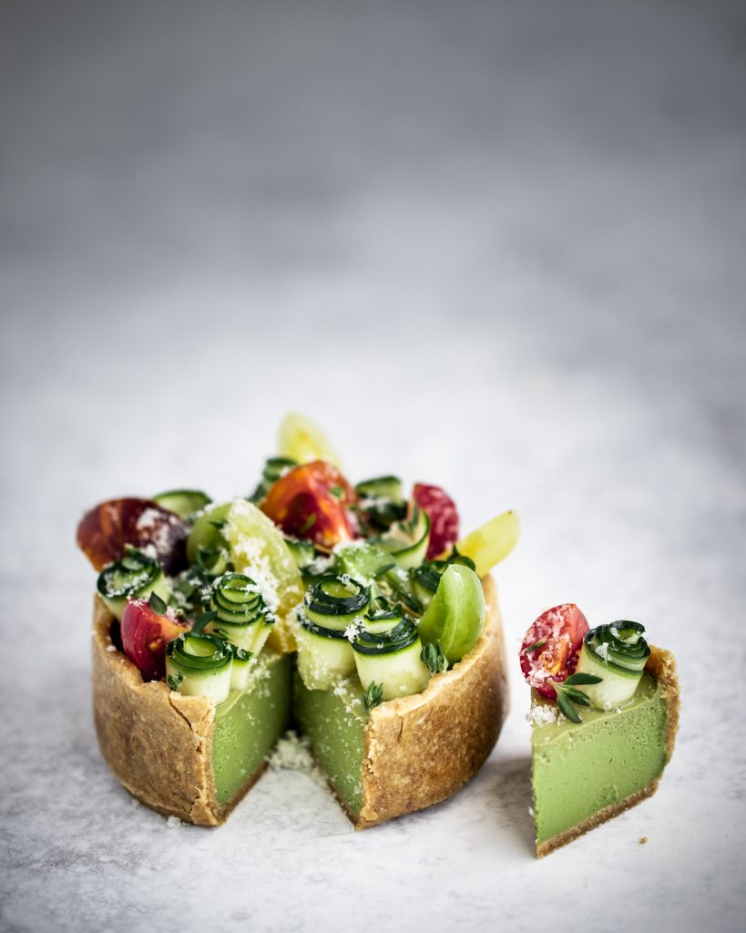 Raw food tomato basil tart on a white background