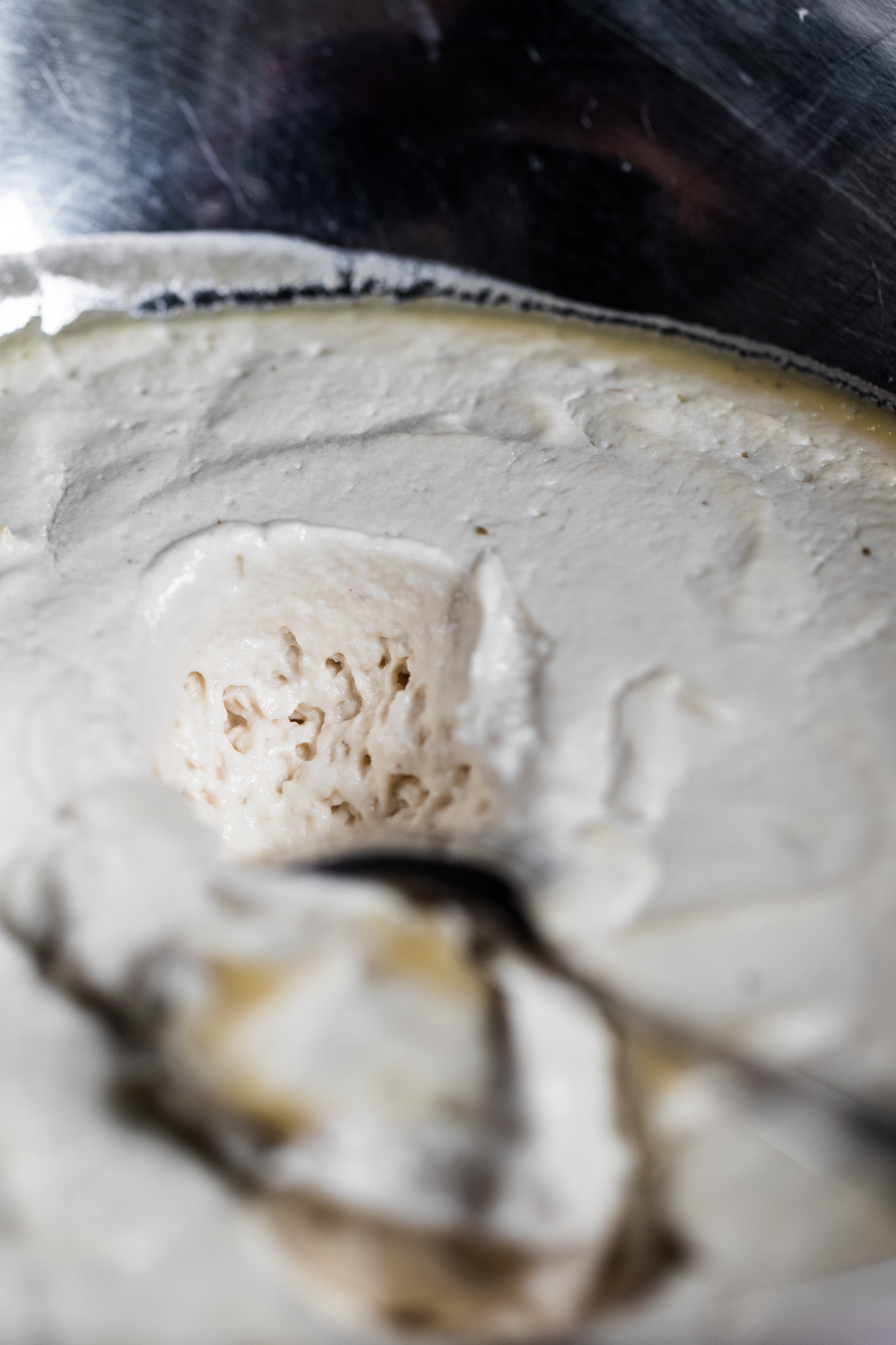 Aerated fermented cashews in a silver bowl with a spoon