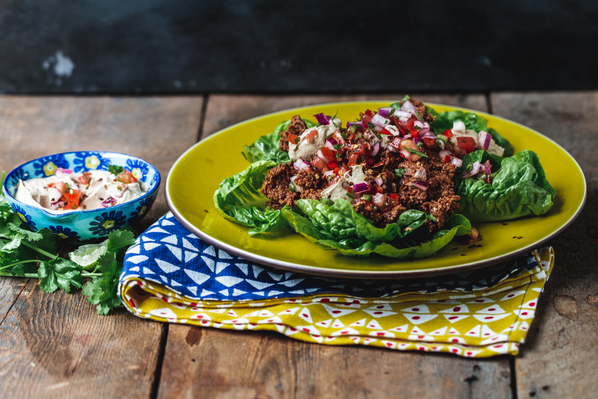 Smoky Maple Sunflower Seed Salad with cashew sour cream on a wooden surface