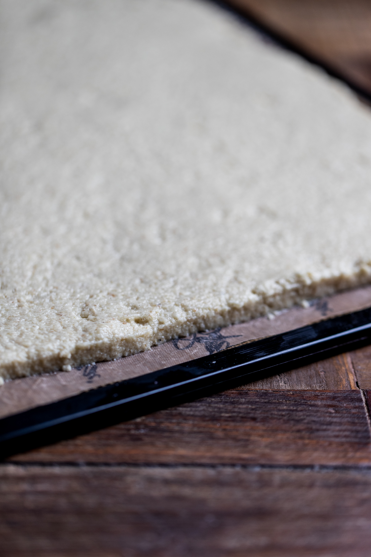 Raw Swiss Roll pastry spread evenly on a nonstick dehydrator sheet