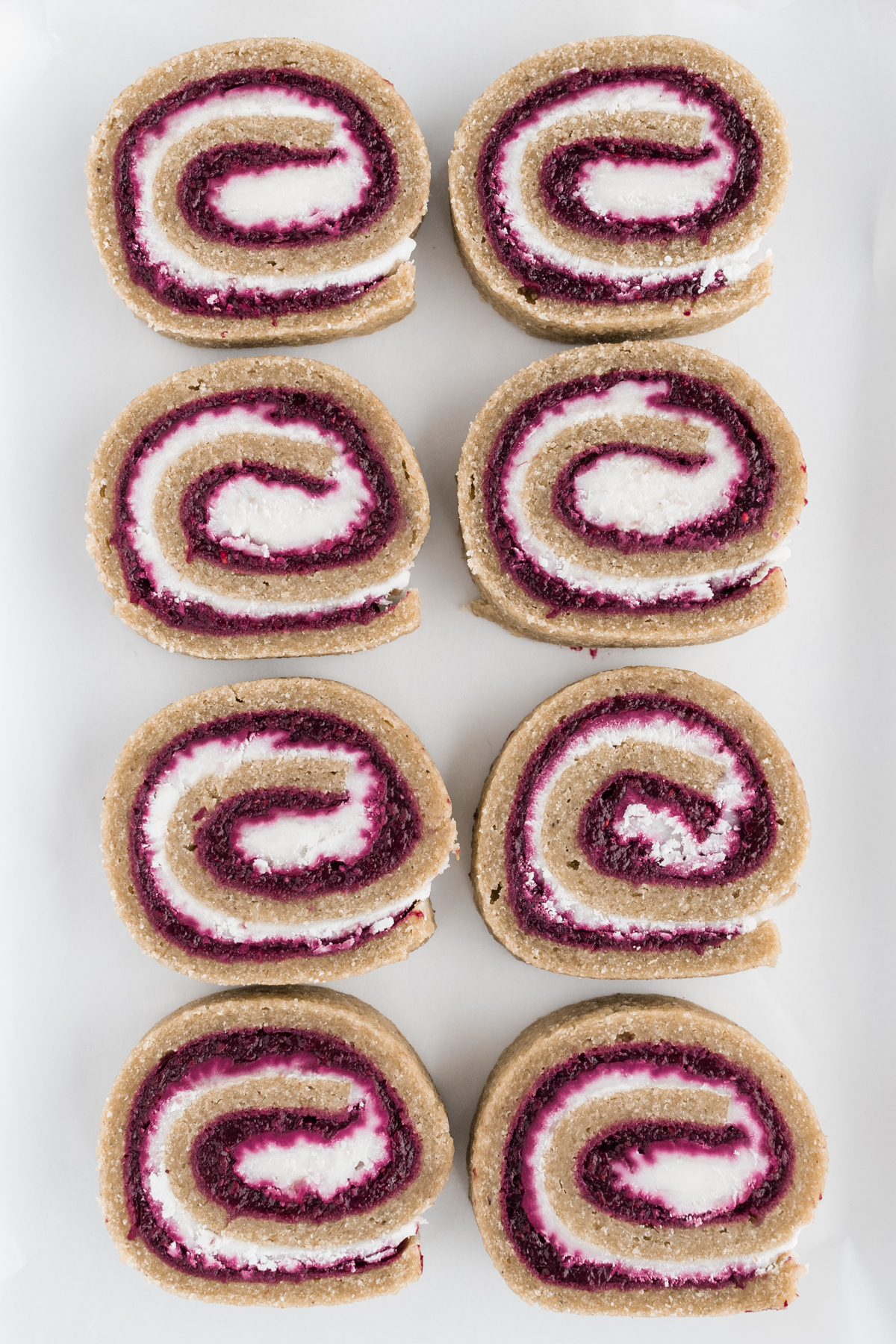 Overhead view of Raw Swiss Roll slices on a white background