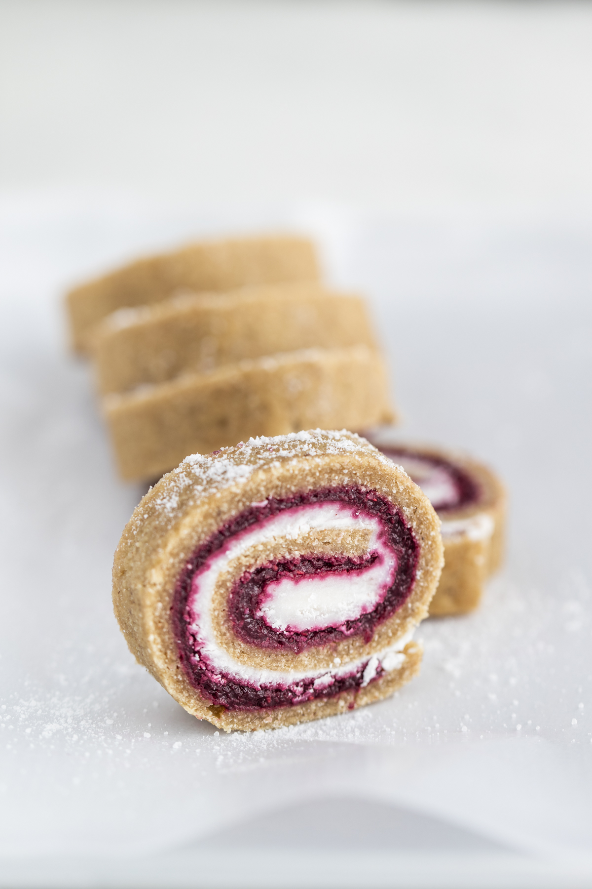 Raw Swiss Roll slice on a white background